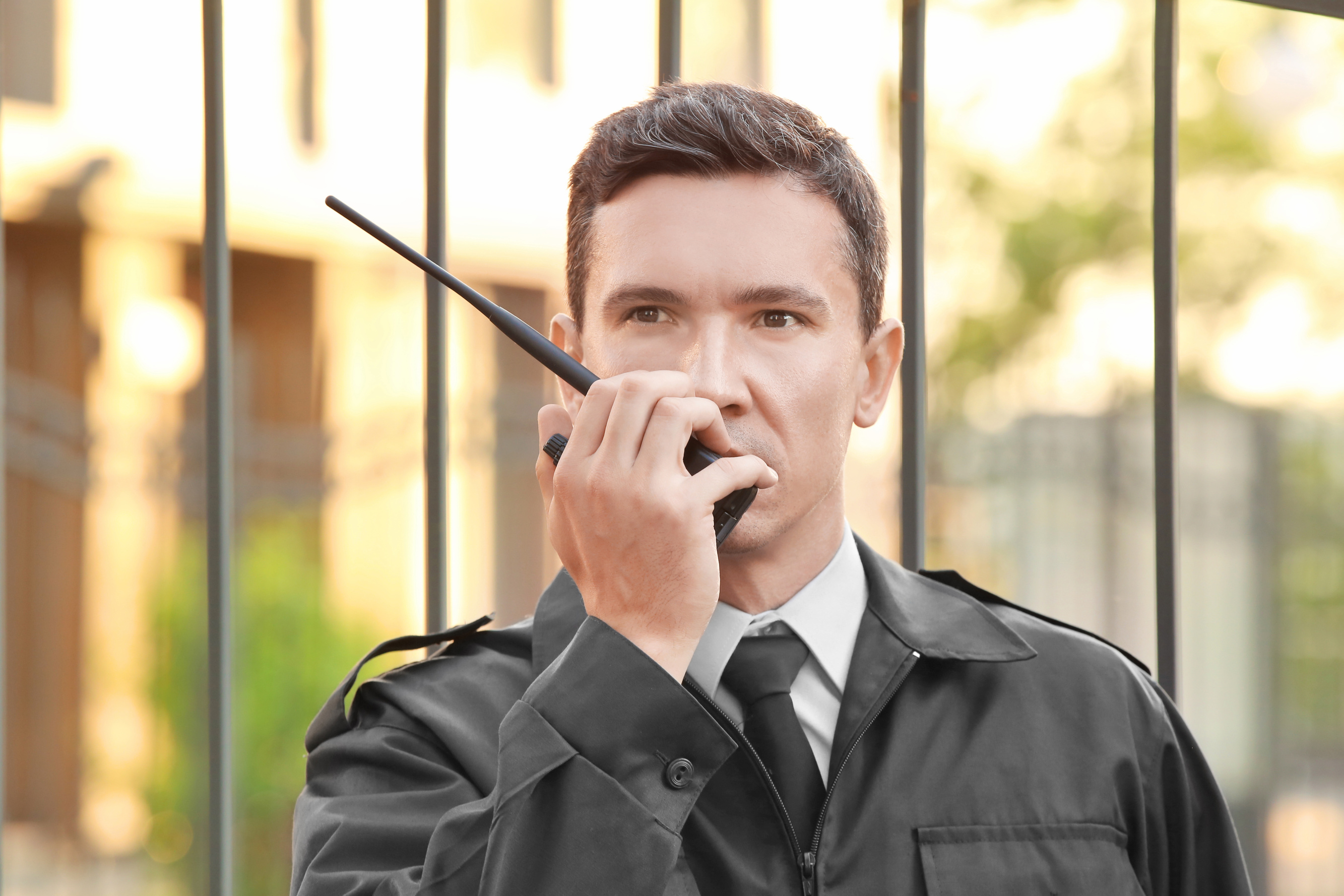 Male Security Guard with Portable Radio, Outdoors